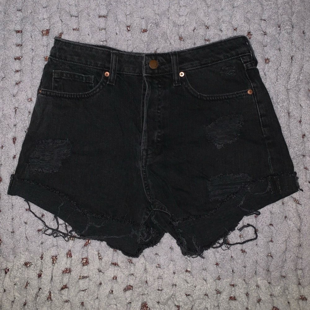 Black distressed jean shorts with holes.